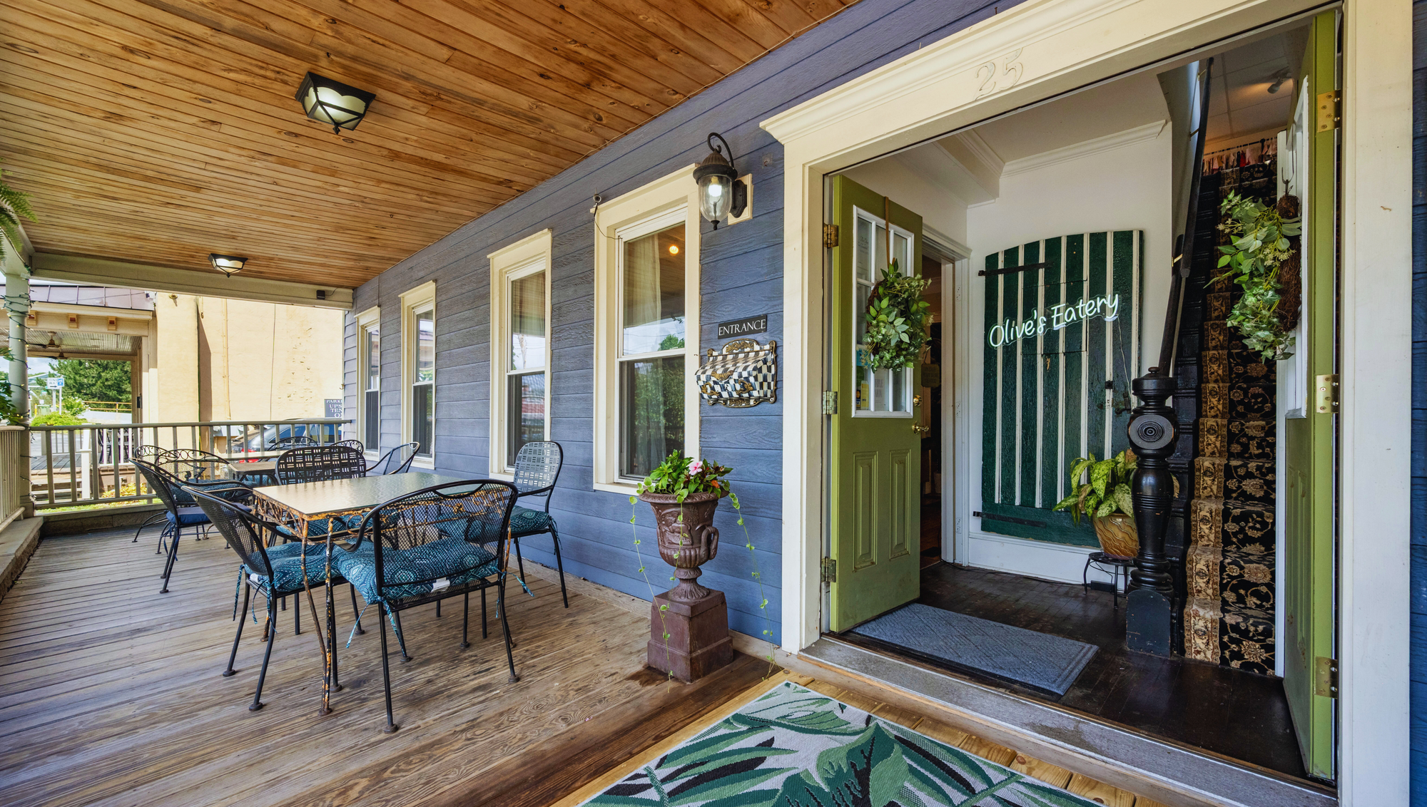 The welcoming front porch and entrance of Olive's Eatery at 25 Syracuse Street, Baldwinsville