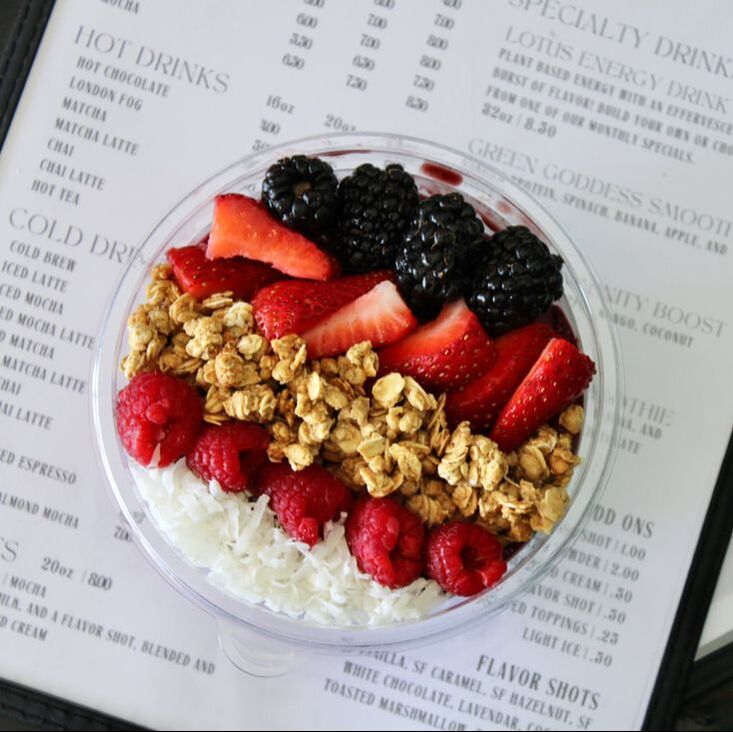 An acai bowl topped with fresh berries, granola and coconut