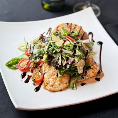 Grilled chicken over dressed greens with balsamic