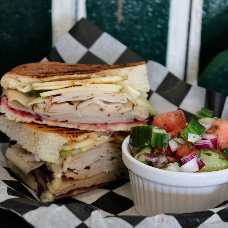 The VV Panini with a side tomato-cucumber salad